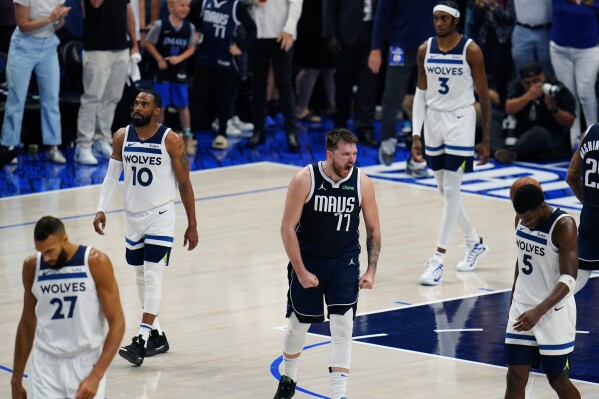 Dallas Mavericks guard Luka Doncic (77) celebrates a play against the Minnesota Timberwolves during the second half in Game 3 of the NBA basketball Western Conference finals, Sunday, May 26, 2024, in Dallas. (AP Photo/Gareth Patterson)