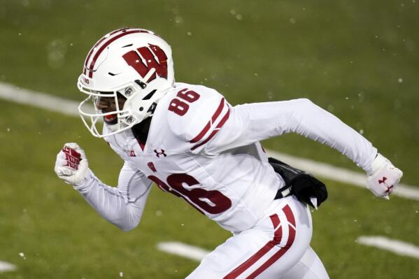 FILE - Wisconsin wide receiver Devin Chandler runs up field during an NCAA college football game against Iowa, on Dec. 12, 2020, in Iowa City, Iowa. Chandler, who transferred to the University of Virginia, was one of three Virginia football players killed in a shooting, Sunday, Nov. 13, 2022, in Charlottesville, Va., while returning from a class trip to see a play. (AP Photo/Charlie Neibergall, File)
