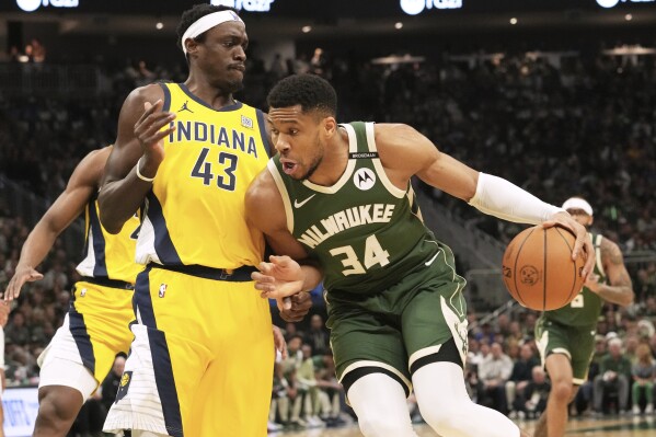 Milwaukee Bucks forward Giannis Antetokounmpo, right, drives against Indiana Pacers forward Pascal Siakam (43) during the first half in Game 3 of an NBA basketball first-round playoff series Friday, April 25, 2025, in Milwaukee. (AP Photo/Nam Y. Huh)