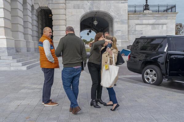 Staff members of House Speaker Nancy Pelosi, including Pelosi's Chief of Staff Terri McCullough, second from right, hug outside of the Capitol, Friday, Oct. 28, 2022, before entering a vehicle on Capitol Hill in Washington. (AP Photo/Jacquelyn Martin)