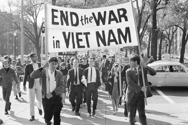 College students from various nearby schools march down Commonwealth Avenue in Boston on Oct. 16, 1965 to attend rally on Boston Common protesting U.S. involvement in Vietnam. (AP Photo/Frank C. Curtin, File)