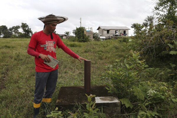 Indigenous leader Filipe Gabriel Mura shows an exploratory well for future drilling of potash, a mineral that includes potassium, in the Lago do Soares village, in Autazes, Amazonas state, Brazil on Feb. 18, 2025. (AP Photo/Edmar Barros)