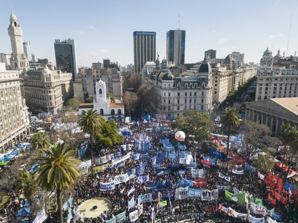 Protesters demanding work opportunities gather in Plaza de Mayo after marching from San Cayetano church to downtown Buenos Aires, Argentina, Wednesday, Aug. 7, 2024, on the feast day of St. Cajetan, known as the patron of the unemployed. (AP Photo/Rodrigo Abd)