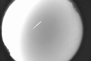This photo provided by NASA shows an Eta Aquarid meteor streaking over northern Georgia on April 29, 2012. (B. Cooke/Marshall Space Flight Center/NASA via AP, File)