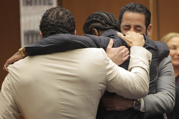 A$AP Rocky, center, is hugged in the courtroom after he was found not guilty during his trial Tuesday, Feb. 18, 2025, in Los Angeles. (Daniel Cole/Pool Photo via AP)