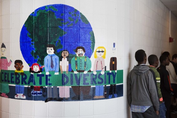 FILE - A mural celebrating diversity decorates a hallway in Lewiston High School in Lewiston, Maine, March 15, 2017. Seventy years after the Supreme Court's Brown v. Board, America is both more diverse — and more segregated. (AP Photo/David Goldman, File)
