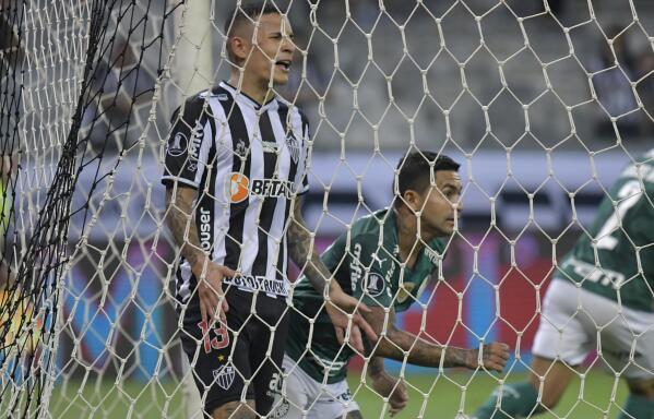 Dudu of Brazil's Palmeiras, right, celebrates after scoring his side's opening goal during a Copa Libertadores semifinal second leg soccer match against Brazil's Atletico Mineiro at the Mineirao stadium in Belo Horizonte, Brazil, Tuesday, Sept. 28, 2021. (Washington Alves/Pool via AP)