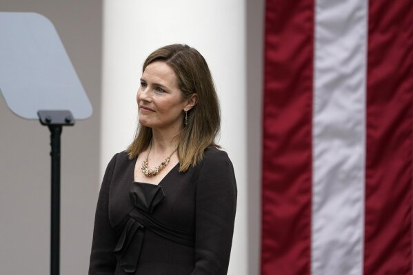 Judge Amy Coney Barrett listens as President Donald Trump announces Barrett as his nominee to the Supreme Court, in the Rose Garden at the White House, Saturday, Sept. 26, 2020, in Washington. (AP Photo/Alex Brandon)