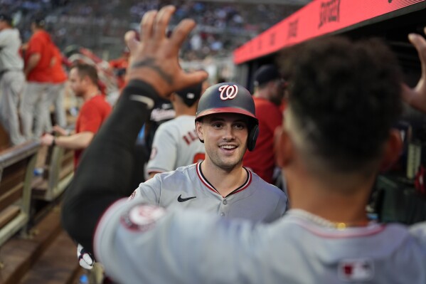 Washington Nationals' Lane Thomas (28) celebrates in the dugout after hitting a three-run home run in the fifth inning of a baseball game against theAtlanta Braves, Wednesday, May 29, 2024, in Atlanta. (AP Photo/Brynn Anderson)