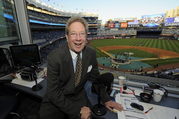 FILE - This Sept. 25, 2009 file photo shows New York Yankees broadcaster John Sterling sitting in his booth before a baseball game against the Boston Red Sox at Yankee Stadium in New York. Yankees radio broadcaster John Sterling was uninjured after he was hit by a foul ball by Justin Turner in the ninth inning of New York's 3-1 win over the Boston Red Sox on Saturday night, June 10, 2023 (AP Photo/Bill Kostroun, file)