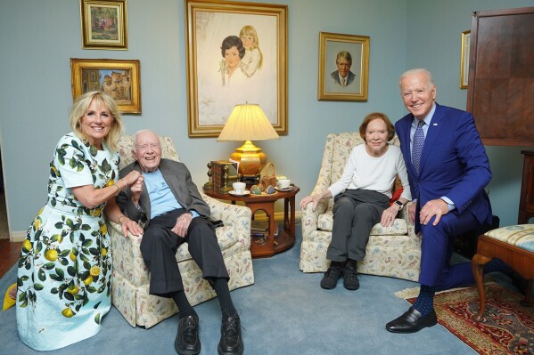 In this photo released by The White House, former President Jimmy Carter, center left, and former first lady Rosalynn Carter, center right, pose for a photo with President Joe Biden, right, and first lady Jill Biden at the home of the Carter's in Plains Ga., April 30, 2021. Former President Donald Trump is running against Biden, but Trump, the presumptive Republican nominee, keeps bringing up Carter. Trump likes to cite the 99-year-old former president as a measuring stick to belittle Biden. (Adam Schultz, The White House via AP)