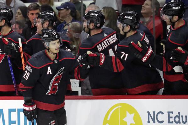 Carolina Hurricanes center Sebastian Aho (20) is congratulated for his second goal of the night as he skates to the bench during the first period of the team's NHL hockey game against the Buffalo Sabres on Friday, Nov. 4, 2022, in Raleigh, N.C. (AP Photo/Chris Seward)