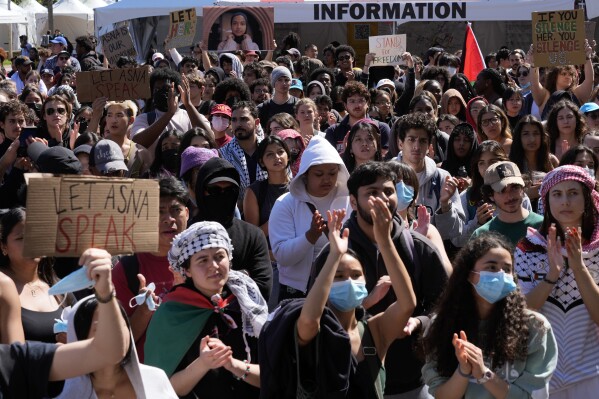 FILE - Students protest a canceled commencement speech by its 2024 valedictorian who has publicly supported Palestinians on the campus of University of Southern California on Thursday, April 18, 2024. U.S. colleges and universities are preparing for end-of-year commencement ceremonies with a unique challenge: providing safety for graduates while honoring the free speech rights of students involved in protests over the Israel-Hamas war. (AP Photo/Damian Dovarganes, File)