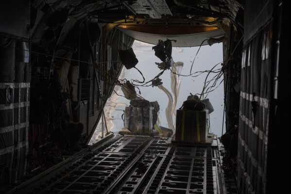 An airplane from U.S. Air force airdrops humanitarian aid over Gaza Strip, Thursday, March 14, 2024. (AP Photo/Leo Correa)