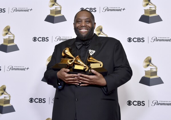 Killer Mike poses in the press room with the awards for best rap performance and best rap song for "Scientists & Engineers," and best rap album for "Michael" during the 66th annual Grammy Awards on Sunday, Feb. 4, 2024, in Los Angeles. (Photo by Richard Shotwell/Invision/AP)