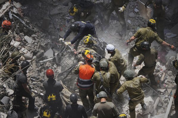 Israeli soldiers search for survivors amid the rubble of residential buildings destroyed by an Iranian missile strike in Bat Yam, central Israel, June 15, 2025. (AP Photo/Ariel Schalit, File)