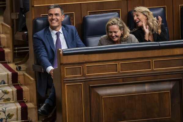 FILE - From left to right: Spain's Socialist Prime Minister Pedro Sanchez, Economy Minister and first Deputy Prime Minister Nadia Calvino and Labor Minister and second Deputy Prime Minister Yolanda Diaz at the Spanish parliament in Madrid, Spain on Friday, Sept. 29, 2023. Women will hold 12 of the 22 posts in the new government named Monday by Spain's recently reelected Socialist Prime Minister Pedro Sanchez. (AP Photo/Bernat Armangue, File)