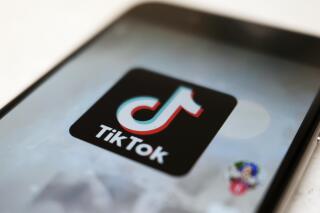 FILE - This Monday, Sept. 28, 2020, file photo, shows the TikTok logo on a smartphone in Tokyo. The Chinese government has made investments in two of the nation's most significant technology firms: ByteDance, the Chinese company that owns global video app TikTok, and Weibo, China's version of Twitter, in a move apparently intended to bolster its sway over the nation's flourishing technology sector. (AP Photo/Kiichiro Sato, File)