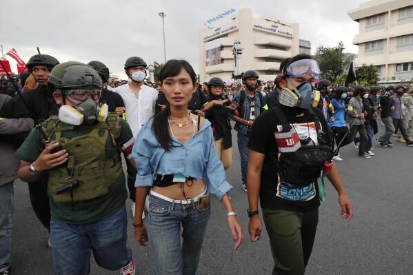 Anti-government protester Chonthicha Jangrew, second from left, marches from Democracy Monument to government house in Bangkok, Thailand on Oct. 14, 2020. Three years ago, tens of thousands of mostly young people in Thailand took to the streets in heated demonstrations seeking democratic reforms. Now, with a general election coming in three weeks, leaders of the country’s progressive movement are hoping to channel the same radical spirit for change though the ballot box. (AP Photo/Sakchai Lalit)