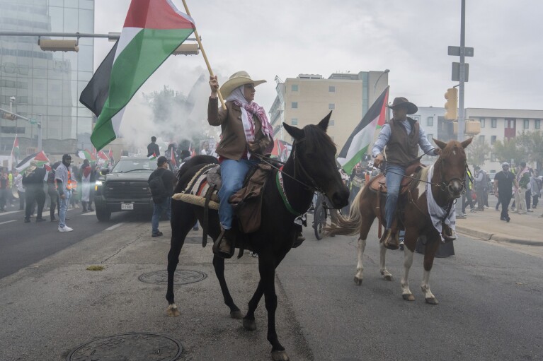 FILE - Mounted pro-Palestinian demonstrators lead the march down San Jacinto Boulevard and through downtown Austin, Texas, following the "All Out For Palestine" rally held at the Texas Capitol in Austin on Nov. 12, 2023. (Sara Diggins/Austin American-Statesman via AP. File)