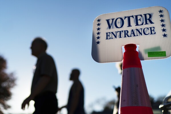 FILE - Voters pass a sign outside a polling site in Warwick, R.I., on Nov. 7, 2022. With the Republican primaries around the corner, a new poll finds that party members aren't sure votes in the presidential nominating contest will be counted accurately. Only about one-third of Republicans say they're confident that tallies in the primary will be accurate. That's according to a new AP-NORC poll. (AP Photo/David Goldman, File)