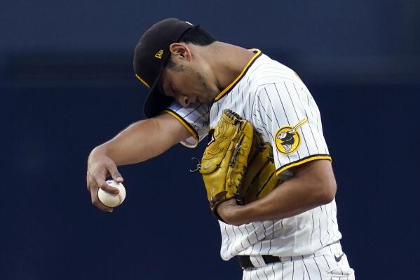 San Diego Padres starting pitcher Yu Darvish wipes his face with a sleeve as he works against a Arizona Diamondbacks batter during the third inning of a baseball game, Monday, June 20, 2022, in San Diego. (AP Photo/Gregory Bull)