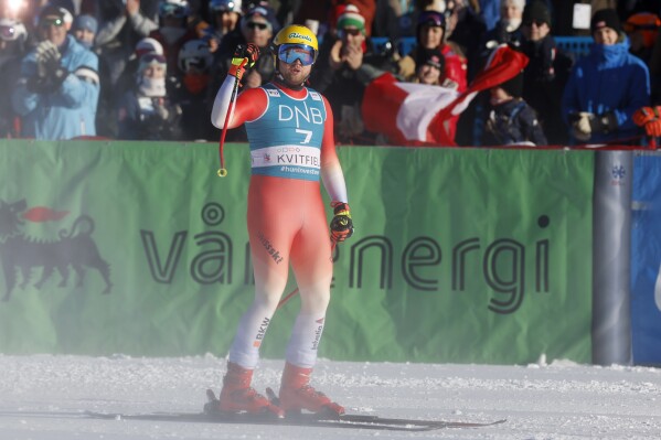 Switzerland's Niels Hintermann celebrates at the finish area of an alpine ski, men's World Cup downhill race, in Kvitfjell, Norway, Saturday, Feb. 17, 2024. (AP Photo/Alessandro Trovati)
