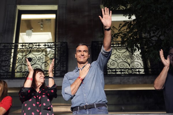 FILE - Socialist Workers' Party leader and current Prime Minster Pedro Sanchez greets supporters outside the party's headquarters in Madrid, Spain, Sunday, July 23, 2023. Ballots from Spaniards living abroad were counted Friday, July 28, and they gave a new twist to the inconclusive results from the general election. The conservative Popular Party gained an additional seat from Madrid’s constituency late in the day at the expense of the Socialist Workers’ Party. (AP Photo/Emilio Morenatti, File)