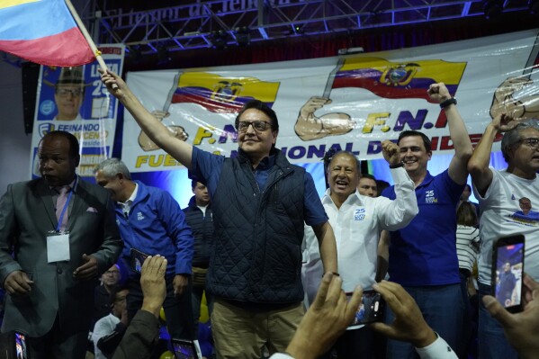 Presidential candidate Fernando Villavicencio waves an Ecuador national flag during a campaign event at a school minutes before he was shot to death outside the same school in Quito, Ecuador, Wednesday, Aug. 9, 2023 (API via AP)