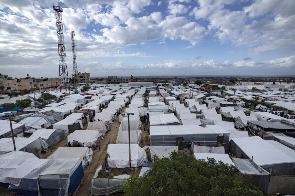 FILE - A U.N. provided tent camp for Palestinians displaced by the Israeli bombardment of the Gaza Strip is seen in Khan Younis, Sunday, Nov. 19, 2023. Since the the fighting began, around 22,000 people have taken shelter there. (AP Photo/Fatima Shbair, File)