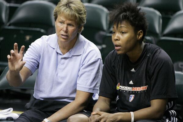 FILE - Phoenix Mercury general manager Ann Meyers Drysdale, left, talks with forward Cappie Pondexter as they wait for the start of practice for the WNBA Finals in Indianapolis, Tuesday, Oct. 6, 2009. The Hall of Famer, long-time TV basketball analyst and mother of three shares how Title IX has shaped her life and career in an essay for The Associated Press, and what needs to be done over the next 50 years for the law to continue to have a positive impact on young girls and women. (AP Photo/Darron Cummings, File)