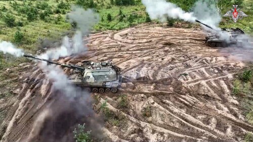 This photo taken from video released by Russian Defense Ministry Press Service on Wednesday, July 19, 2023, shows two Russian 152 mm self-propelled howitzers fire toward Ukrainian positions at an undisclosed location. (Russian Defense Ministry Press Service via AP)