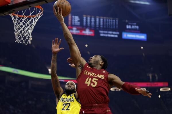 Cleveland Cavaliers guard Donovan Mitchell (45) shoots against Indiana Pacers forward Isaiah Jackson (22) during the first half of an NBA basketball game, Sunday, April 2, 2023, in Cleveland. (AP Photo/Ron Schwane)
