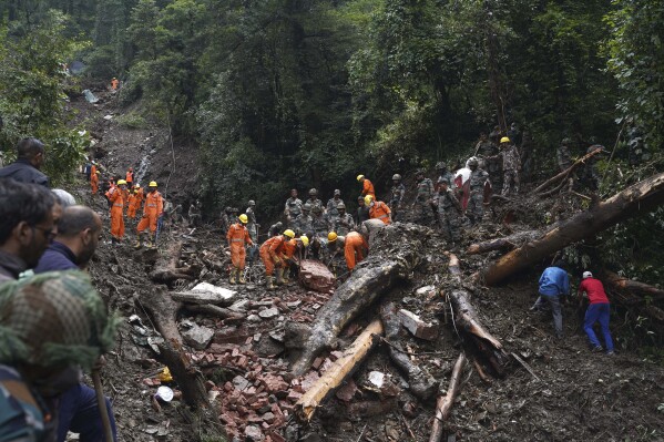 Rescuers search the debris for survivors after a landslide following heavy rainfall in Shimla, India, Thursday, Aug. 17, 2023. Days of relentless rain in India’s Himalayan region have killed more than 70 people this week as a heavy monsoon triggered landslides and flash floods that have submerged roads, washed away buildings and left residents scrambling for safety. AP Photo/Pradeep Kumar)
