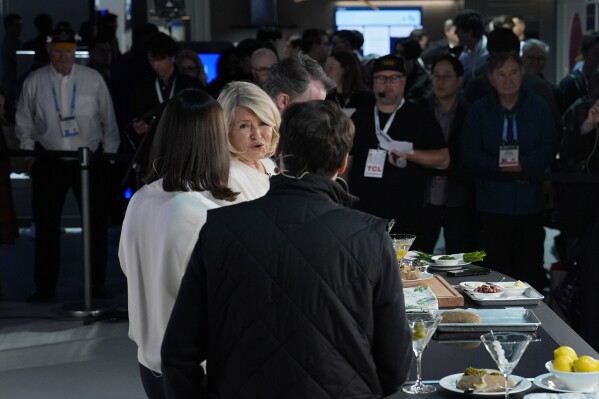 Martha Stewart, center, speaks at the Samsung booth during the CES tech show, Tuesday, Jan. 9, 2024, in Las Vegas. (AP Photo/John Locher)