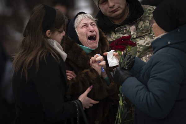 Nina Nikiforovа, 80, cries outside a church in Kyiv, Ukraine, on Feb. 11, 2023, after attending the funeral of her son Oleg Kunynets, a Ukrainian military serviceman who was killed in the east of the country. (AP Photo/Emilio Morenatti)
