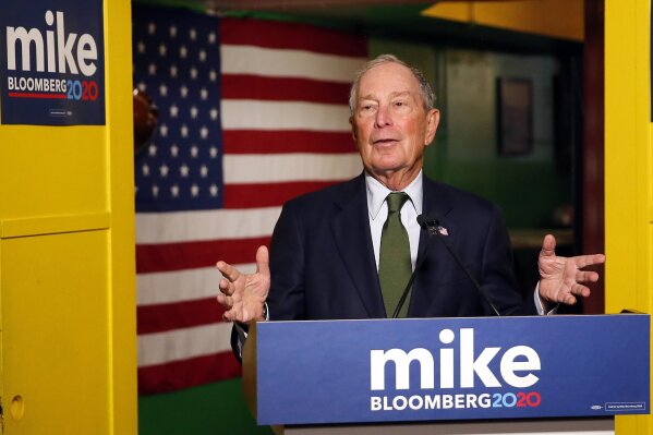 FILE - In this Nov. 26, 2019, file photo, Democratic presidential candidate Michael Bloomberg speaks to the media in Phoenix. Democrats are narrowing Donald Trump's early spending advantage, with two billionaire White House hopefuls joining established party groups to target the president in key battleground states that are likely to determine the outcome of next year's election.(AP Photo/Rick Scuteri, File)