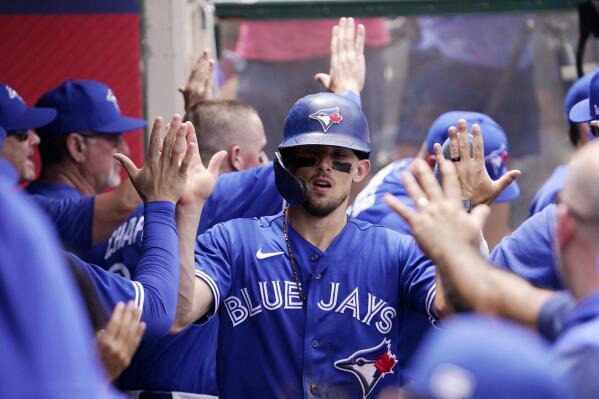 Toronto Blue Jays' Cavon Biggio is congratulated by teammates in the dugout after scoring on a double by Lourdes Gurriel Jr. during the second inning of a baseball game against the Los Angeles Angels Sunday, May 29, 2022, in Anaheim, Calif. (AP Photo/Mark J. Terrill)