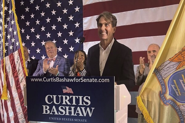 The photo shows Republican Senate candidate Curtis Bashaw at a lectern speaking Tuesday June 4, 2024, at the Congress Hall hotel in Cape May, N.J. Bashaw defeated Mendham Borough Mayor Christine Serrano Glassner in Tuesday’s primary despite her endorsement by Donald Trump. (Jeanette Hoffman via AP)