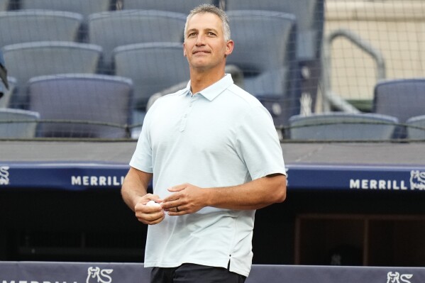 Former New York Yankees pitcher Andy Pettitte walks on the field to throw out a ceremonial first pitch before a baseball game between the Yankees and the New York Mets, Tuesday, July 25, 2023, in New York. (AP Photo/Frank Franklin II)