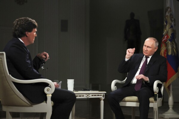 In this photo released by Sputnik news agency on Friday, Feb. 9, 2024, Russian President Vladimir Putin, right, speaks during an interview with former Fox News host Tucker Carlson at the Kremlin in Moscow, Russia, Tuesday, Feb. 6, 2024.  (Gavriil Grigorov, Sputnik, Kremlin, Pool Photo via AP, File)