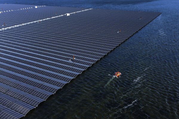 A floating solar farm operates on the Cottbuser Ostsee lake near Cottbus, Germany, Oct. 16, 2024. (AP Photo/Matthias Schrader, File)