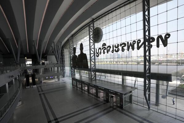 A lone passenger walks outside the main entrance of the Krung Thep Aphiwat Central Terminal in Bangkok, Thailand, Tuesday, Jan. 17, 2023. Thailand ushered in a new age of train travel on Thursday when what’s said to be Southeast Asia’s biggest railway station officially began operations. (AP Photo/Sakchai Lalit)