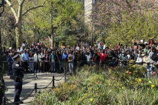 Immigrants rally at City Hall Park outside City Hall in New York on Tuesday, April 16, 2024. Social media users are falsely claiming that the immigrants stormed City Hall to demand housing in luxury hotels. (AP Photo/Cedar Attanasio)