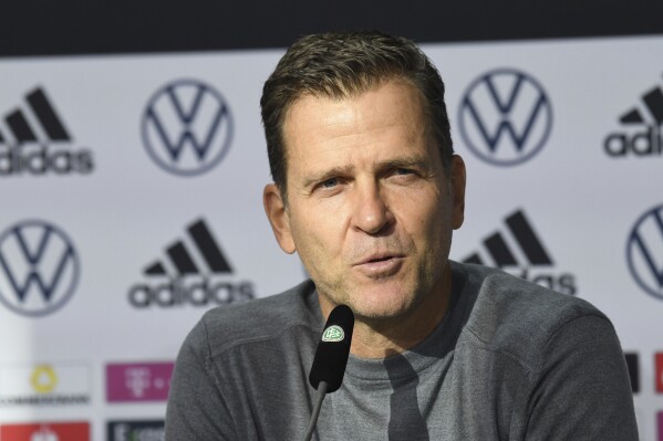 FILE - DFB director Oliver Bierhoff talks to the media at a press conference wearing mouth-nose protection in Wolfsburg, Germany, prior the World Cup qualifying match against Liechtenstein, Tuesday, Nov. 9, 2021. The New England Patriots have enlisted Bierhoff, the former director of Germany's national soccer teams, to help them team expand their fan base and business connections in Germany, Switzerland and Austria. (Swen Pfoertner/dpa via AP, File)