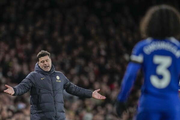 Chelsea's head coach Mauricio Pochettino, left, reacts during the English Premier League soccer match between Arsenal and Chelsea at Emirates Stadium in London, Tuesday, April 23, 2024. (AP Photo/Kin Cheung)