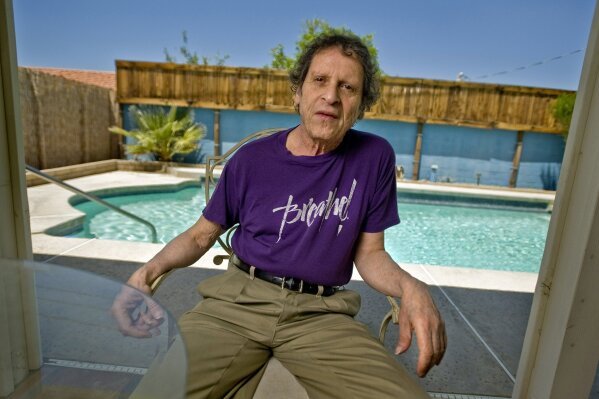 FILE - In this May 7, 2009, file photo, author, comedian and co-founder of the Yippie party as well as stand-up satirist, Paul Krassner, 77, poses for a photo at his home in Desert Hot Springs, Calif. Krassner, the publisher, author and radical political activist on the front lines of 1960s counterculture who helped tie together his loose-knit prankster group by naming them the Yippies, has died. His daughter, Holly Krassner Dawson, says Krassner died Sunday, July 21, 2019, at his home in Desert Hot Springs, Calif. He was 87. (AP Photo/Eric Reed, File)