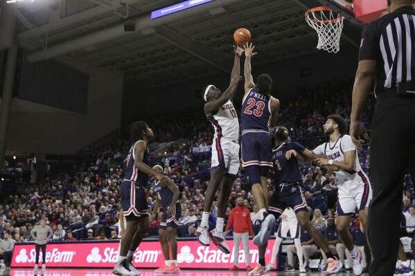 Gonzaga forward Graham Ike (13) shoots while pressured by Jackson State forward Jordan O'Neal (23) during the first half of an NCAA college basketball game, Wednesday, Dec. 20, 2023, in Spokane, Wash. (AP Photo/Young Kwak)