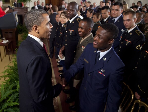 FILE - President Barack Obama greets service members after they became U.S. citizens during a naturalization ceremony in the East Room of the White House in Washington, July 4, 2012. (AP Photo/Evan Vucci, File)