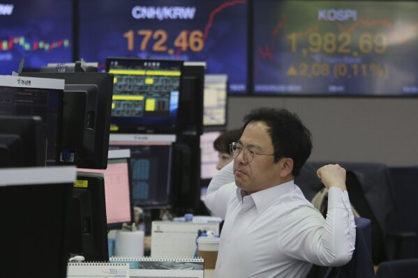 A currency trader watches monitors at the foreign exchange dealing room of the KEB Hana Bank headquarters in Seoul, South Korea, Wednesday, May 20, 2020.  Asian shares were mixed Wednesday as market players waffled between hopes for recovery as economies gradually reopen and worries over the havoc wreaked by the pandemic. (AP Photo/Ahn Young-joon)